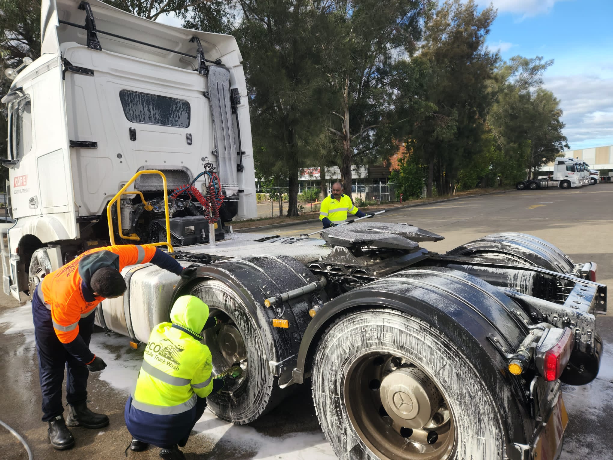 Professional mobile truck cleaning team at work
