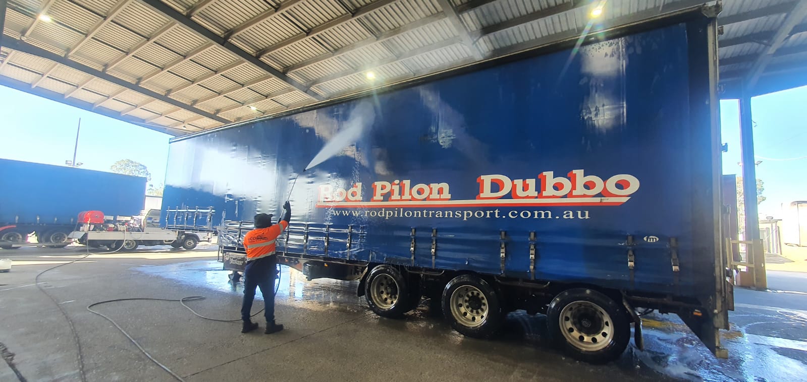 Fleet of trucks receiving mobile washing service